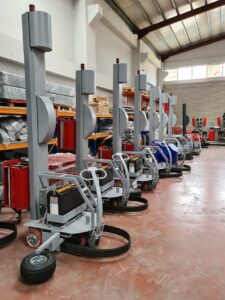 Automatic wrapping machines aligned in a Gaziantep warehouse, showcasing industrial technology.