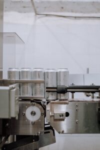 Vertical shot of aluminum cans on a conveyor in a factory setting, showcasing industrial processes.